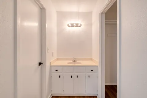 a bathroom with a granite countertop sink and a mirror