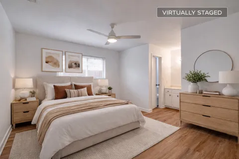 a bedroom with a bed and a dresser