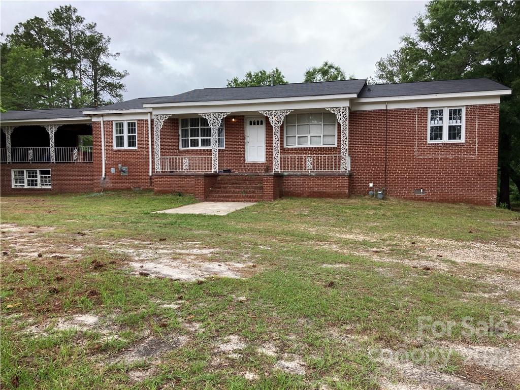 601 Sharpe Road Columbia, SC 29203 - Photo 1 of 32 a backyard of a house with barbeque oven fire pit table and chairs