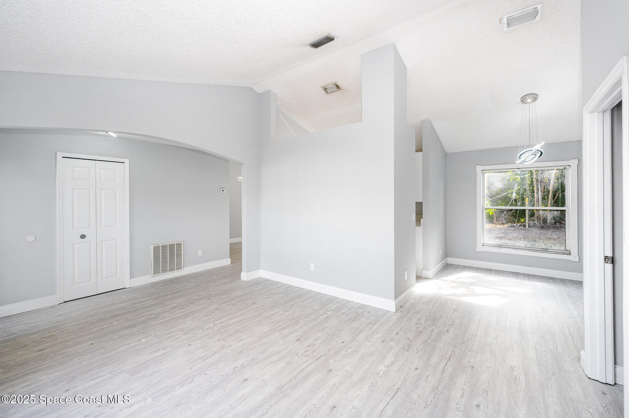 4285 Glover Street Cocoa, FL 32927 - Photo 14 of 25 an empty room with wooden floor and windows