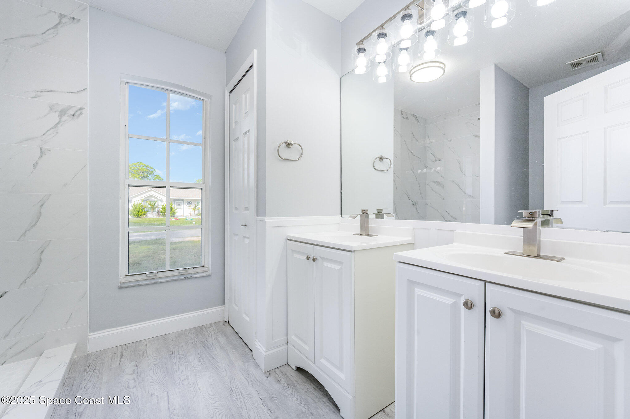 4285 Glover Street Cocoa, FL 32927 - Photo 2 of 25 a bathroom with a double vanity sink and a mirror
