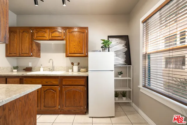 a kitchen with a refrigerator and sink