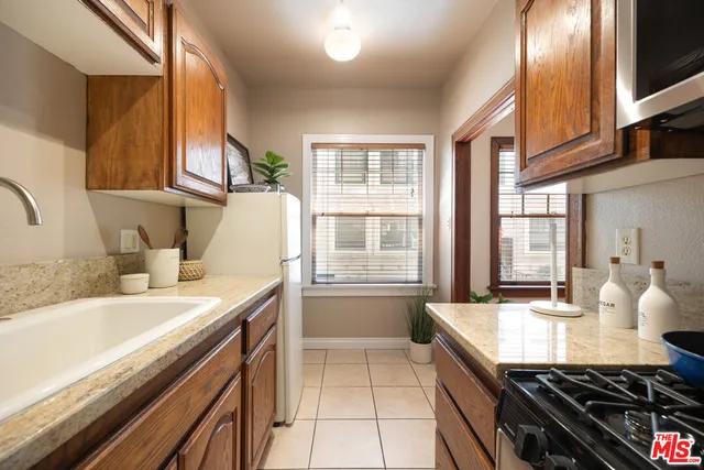 a kitchen with a sink stove and cabinets