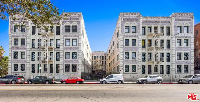 a buildings with car parked in front of it
