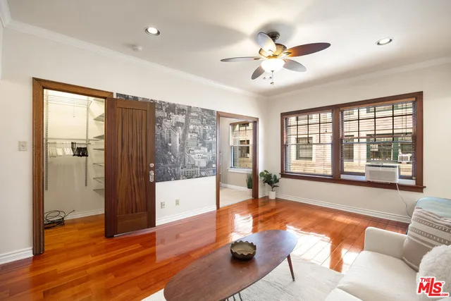 a living room with hardwood floor and a large window