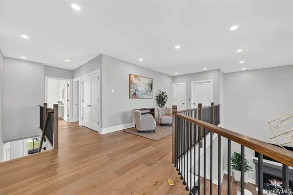 a view of a hallway with the couches and dining room view