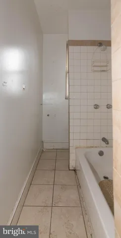 a bathroom with a bathtub and shower