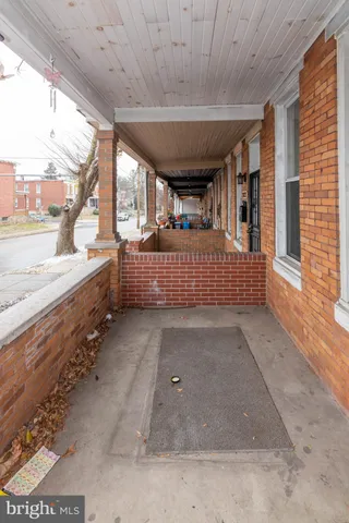 a view of a porch with furniture and a gate