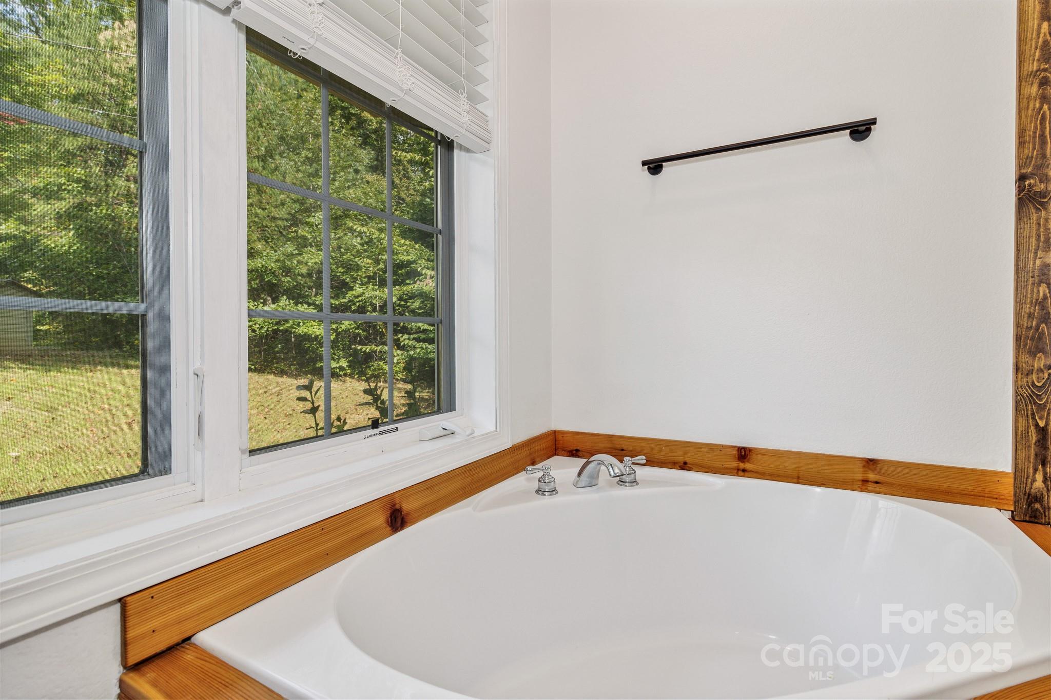 939 Morgan Hill Road Black Mountain, NC 28711 - Photo 18 of 48 a white bath tub sitting in a bathroom next to a window
