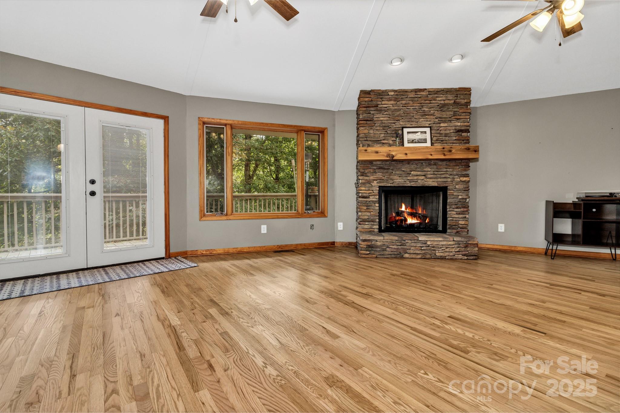 939 Morgan Hill Road Black Mountain, NC 28711 - Photo 27 of 48 a view of an empty room with wooden floor fireplace and a window
