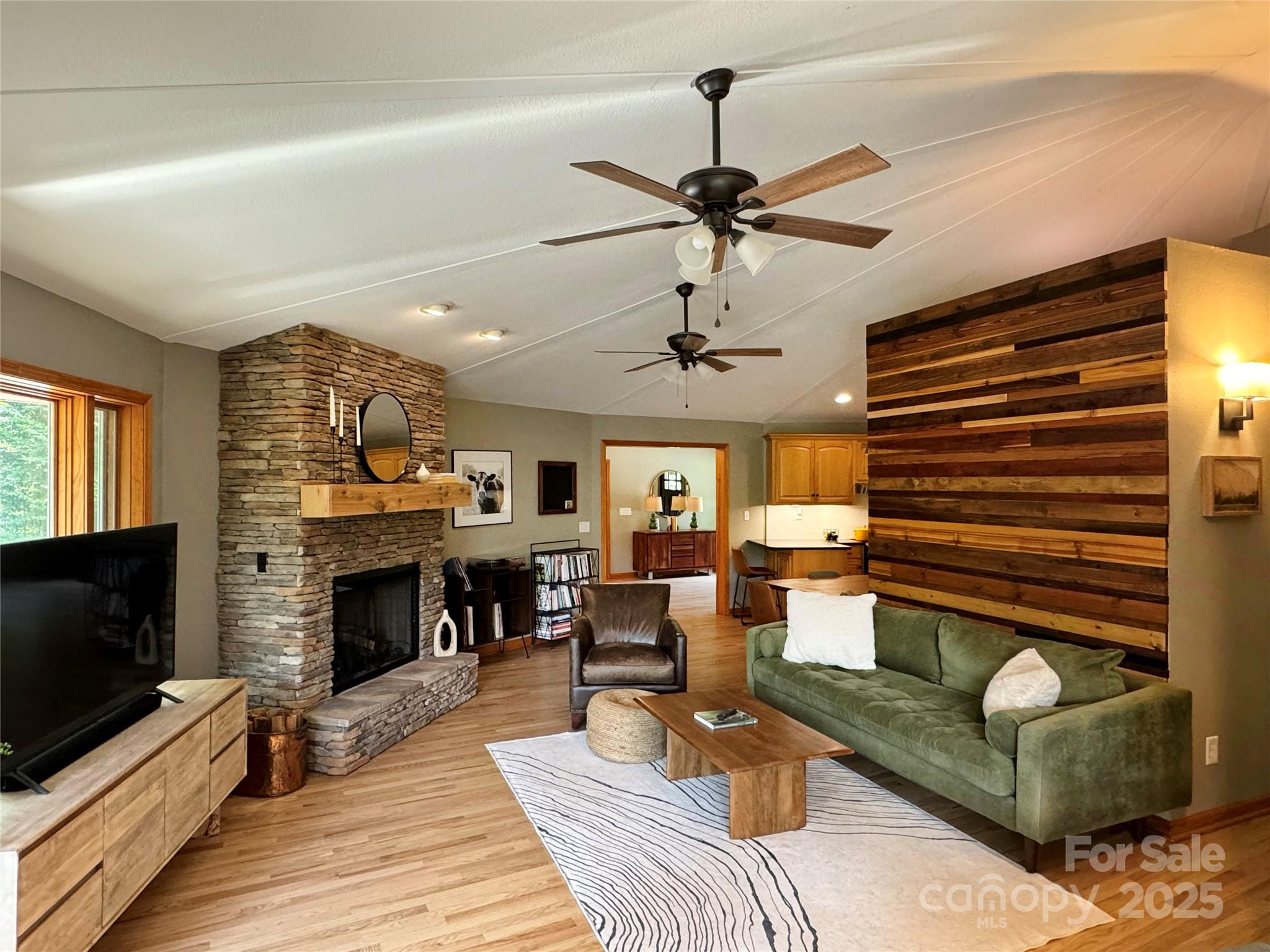 939 Morgan Hill Road Black Mountain, NC 28711 - Photo 3 of 48 a living room with furniture a flat screen tv and a fireplace