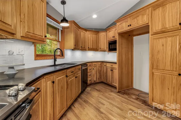 a view of kitchen with wooden floor and window
