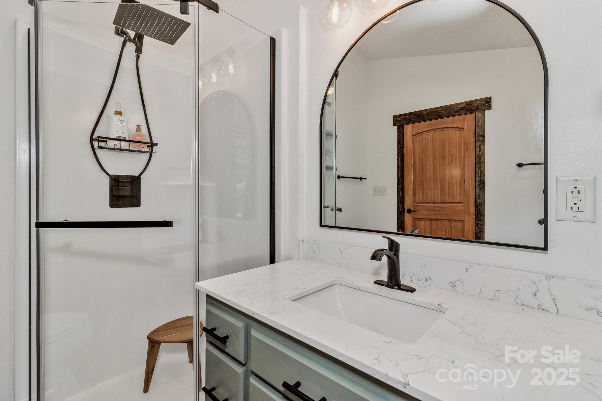 939 Morgan Hill Road Black Mountain, NC 28711 - Photo 37 of 48 a bathroom with a sink and a mirror