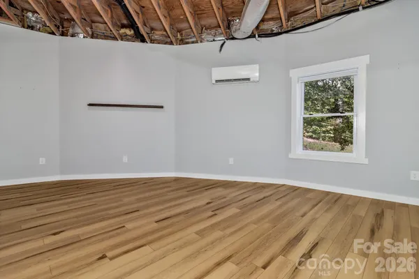 a view of a room with wooden floor