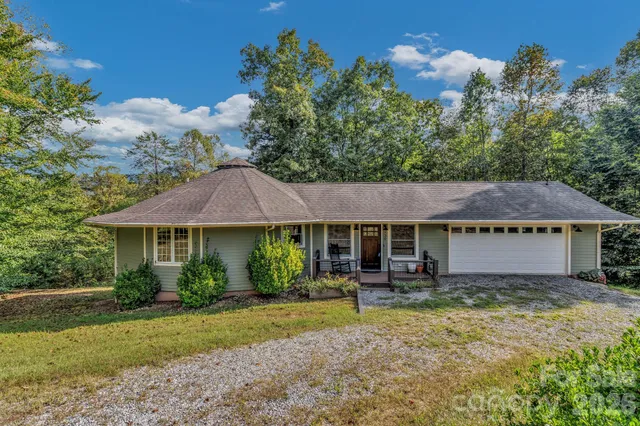 a view of a hallway with wooden floor and a ceiling fan