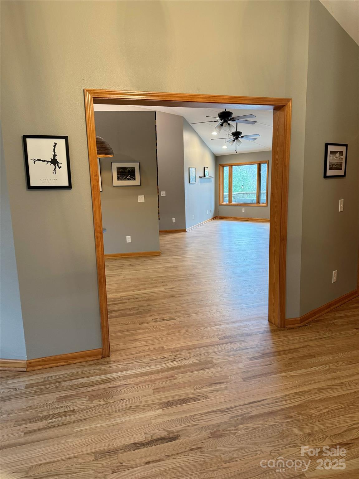 939 Morgan Hill Road Black Mountain, NC 28711 - Photo 9 of 48 a view of a hallway with wooden floor and a ceiling fan