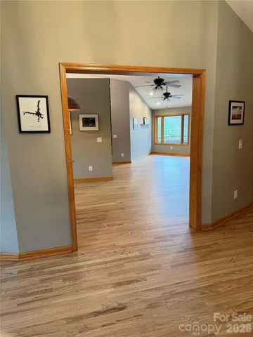a view of kitchen and living room with wooden floor