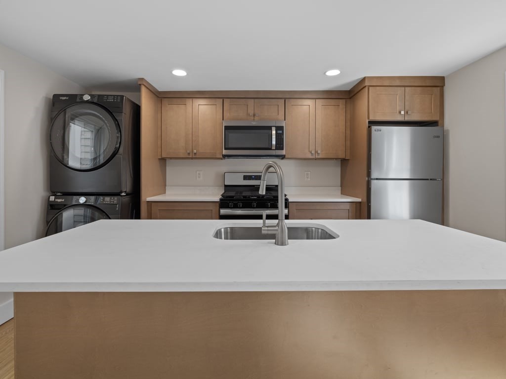 40 Cedar Street Wellesley, MA 02481 - Photo 1 of 23 a kitchen with a refrigerator a sink and a stove top oven