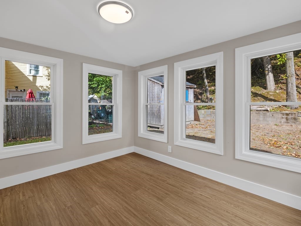 40 Cedar Street Wellesley, MA 02481 - Photo 12 of 23 a view of an empty room with wooden floor and a window