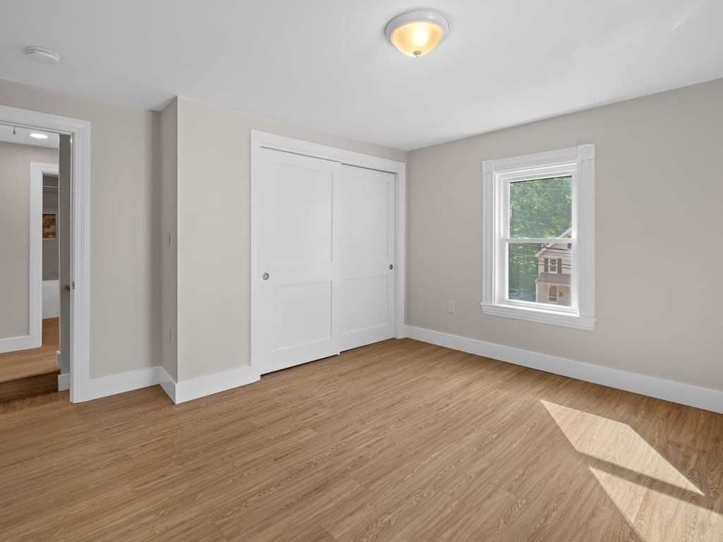 40 Cedar Street Wellesley, MA 02481 - Photo 15 of 23 a view of an empty room with wooden floor and a window