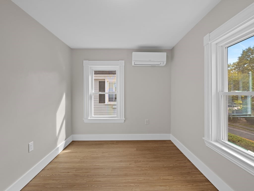 40 Cedar Street Wellesley, MA 02481 - Photo 17 of 23 a view of an empty room with wooden floor and a window