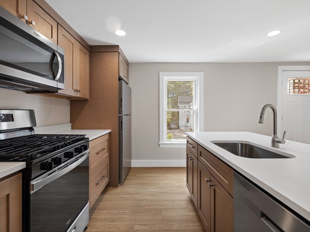 40 Cedar Street Wellesley, MA 02481 - Photo 2 of 23 a kitchen with stainless steel appliances granite countertop a sink and a stove