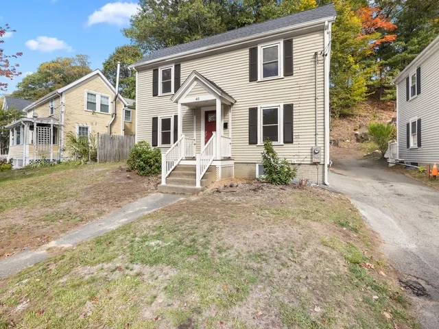 a view of a house with a yard and porch