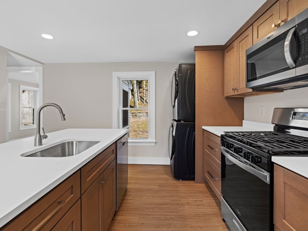 40 Cedar Street Wellesley, MA 02481 - Photo 3 of 23 a kitchen with stainless steel appliances granite countertop a sink stove and refrigerator