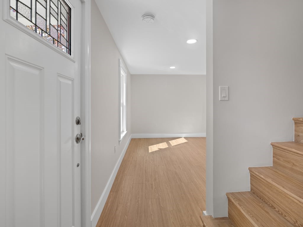 40 Cedar Street Wellesley, MA 02481 - Photo 5 of 23 a view of a hallway with wooden floor and staircase