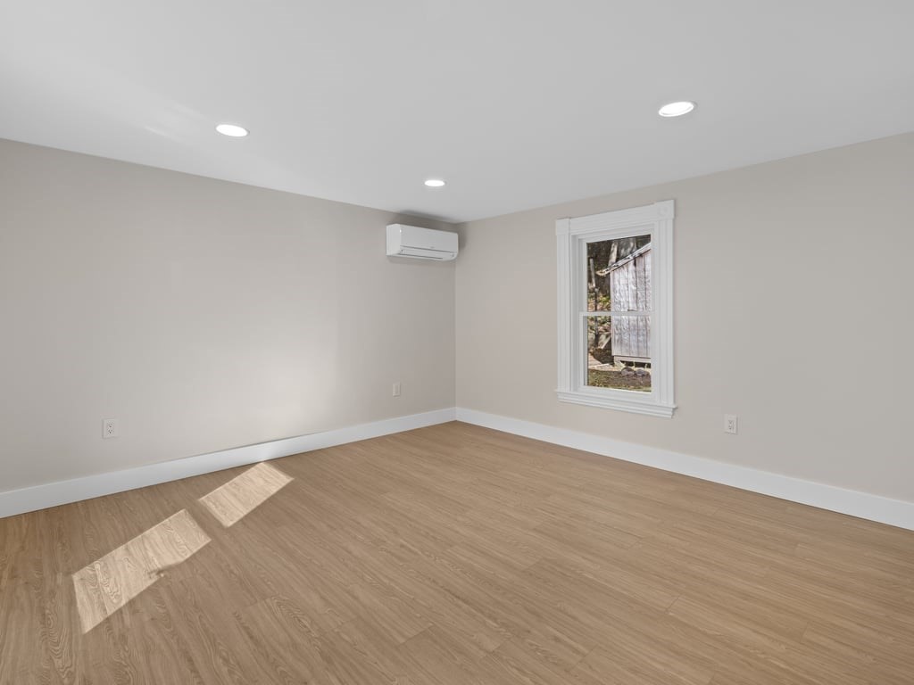 40 Cedar Street Wellesley, MA 02481 - Photo 7 of 23 a view of an empty room with wooden floor and a window