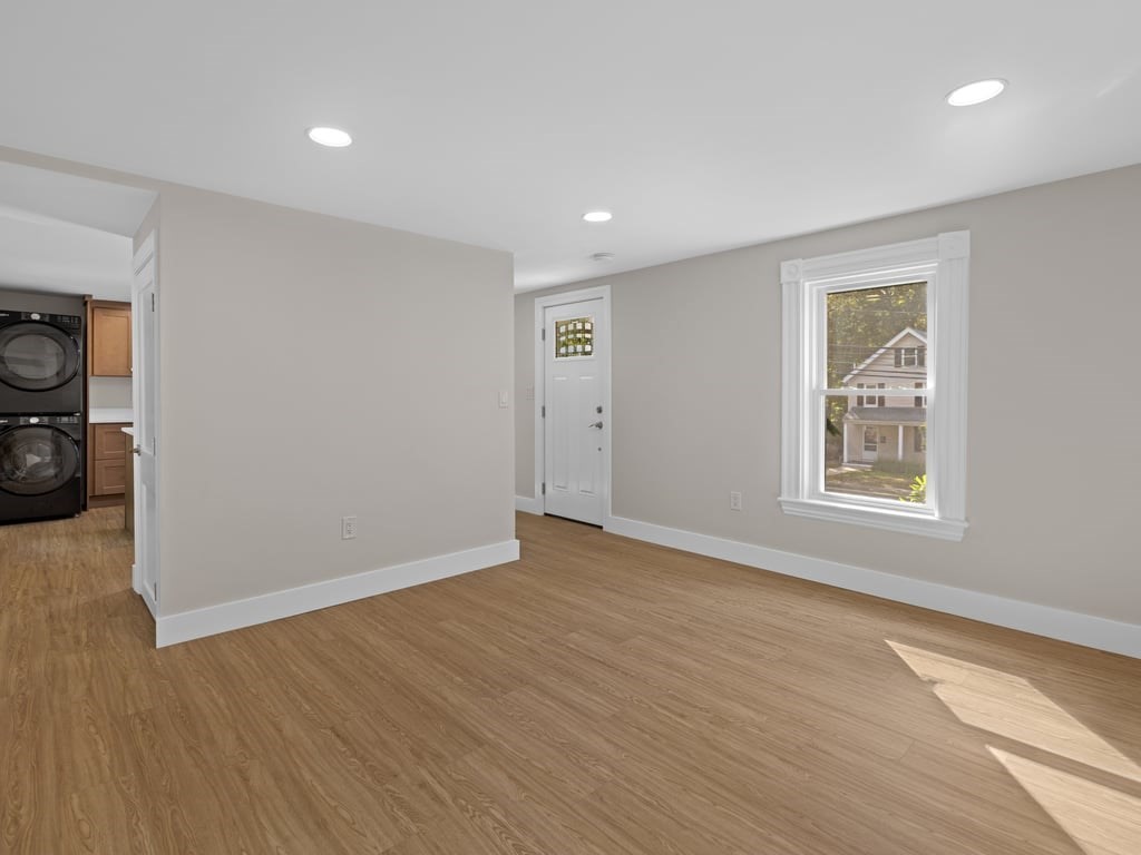 40 Cedar Street Wellesley, MA 02481 - Photo 9 of 23 a view of an empty room with wooden floor and a window