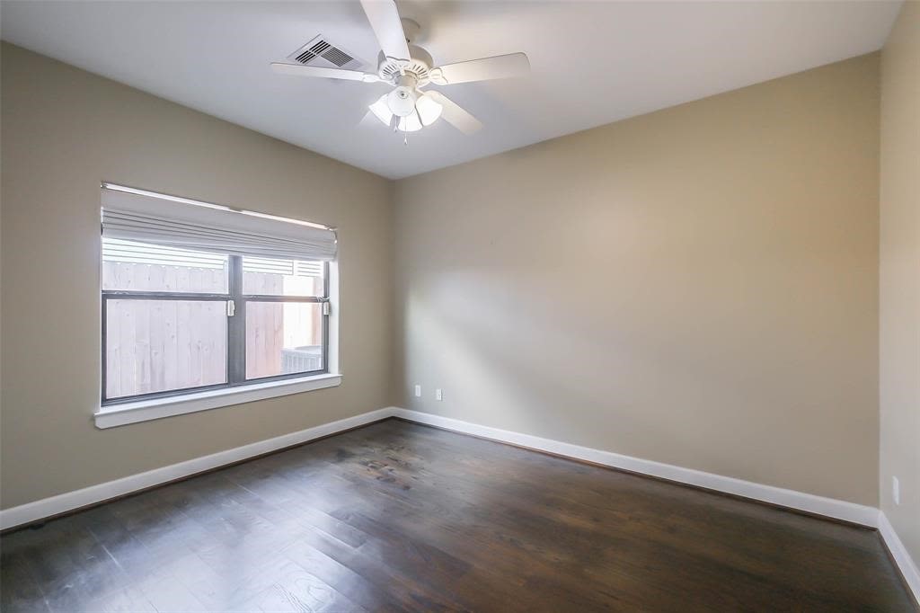 706 Allston Street, Unit B Houston, TX 77007 - Photo 11 of 33 an empty room with wooden floor and windows