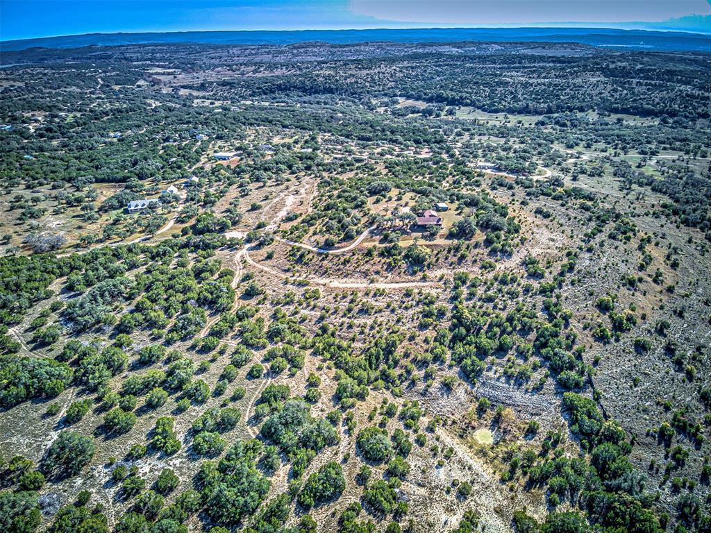 414 Hall Lane Spicewood, TX 78669 - Photo 3 of 16 a view of a large building with a field
