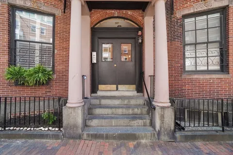 a view of a brick house with a large windows