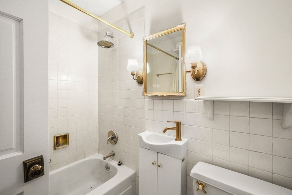 27 Bowdoin Street, Unit 1C Boston, MA 02114 - Photo 7 of 16 a bathroom with a sink and a mirror