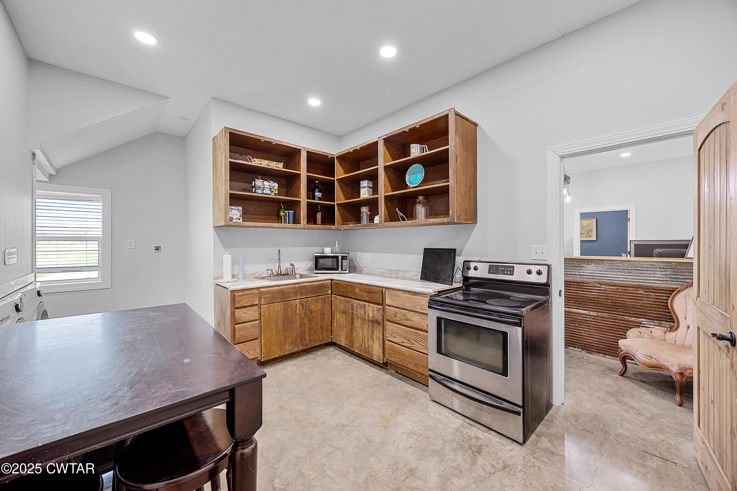 90 Dawson Bottom Road Humboldt, TN 38343 - Photo 11 of 24 a kitchen with a stove a sink and a refrigerator
