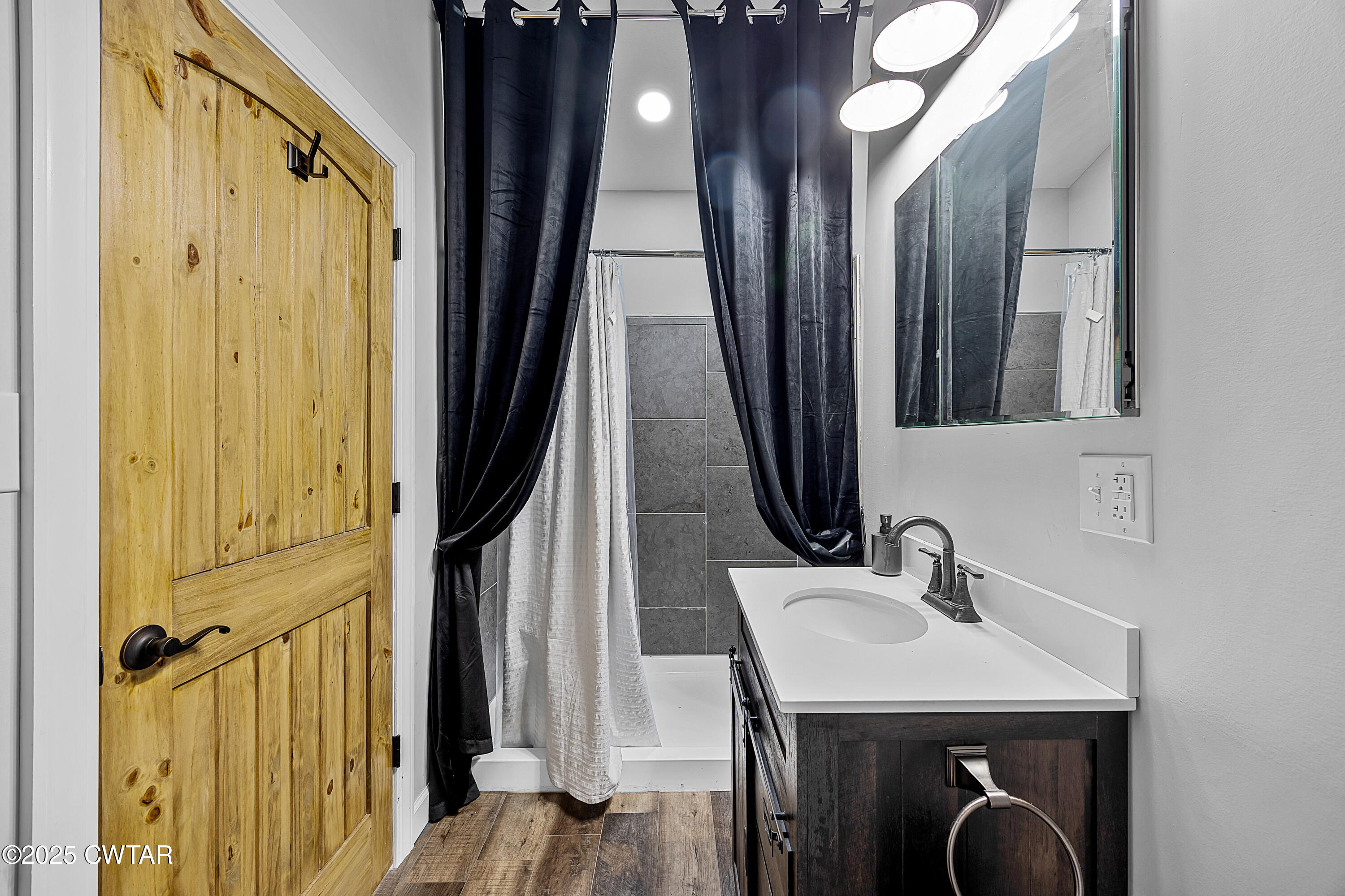 90 Dawson Bottom Road Humboldt, TN 38343 - Photo 17 of 24 a hallway with a sink and mirror