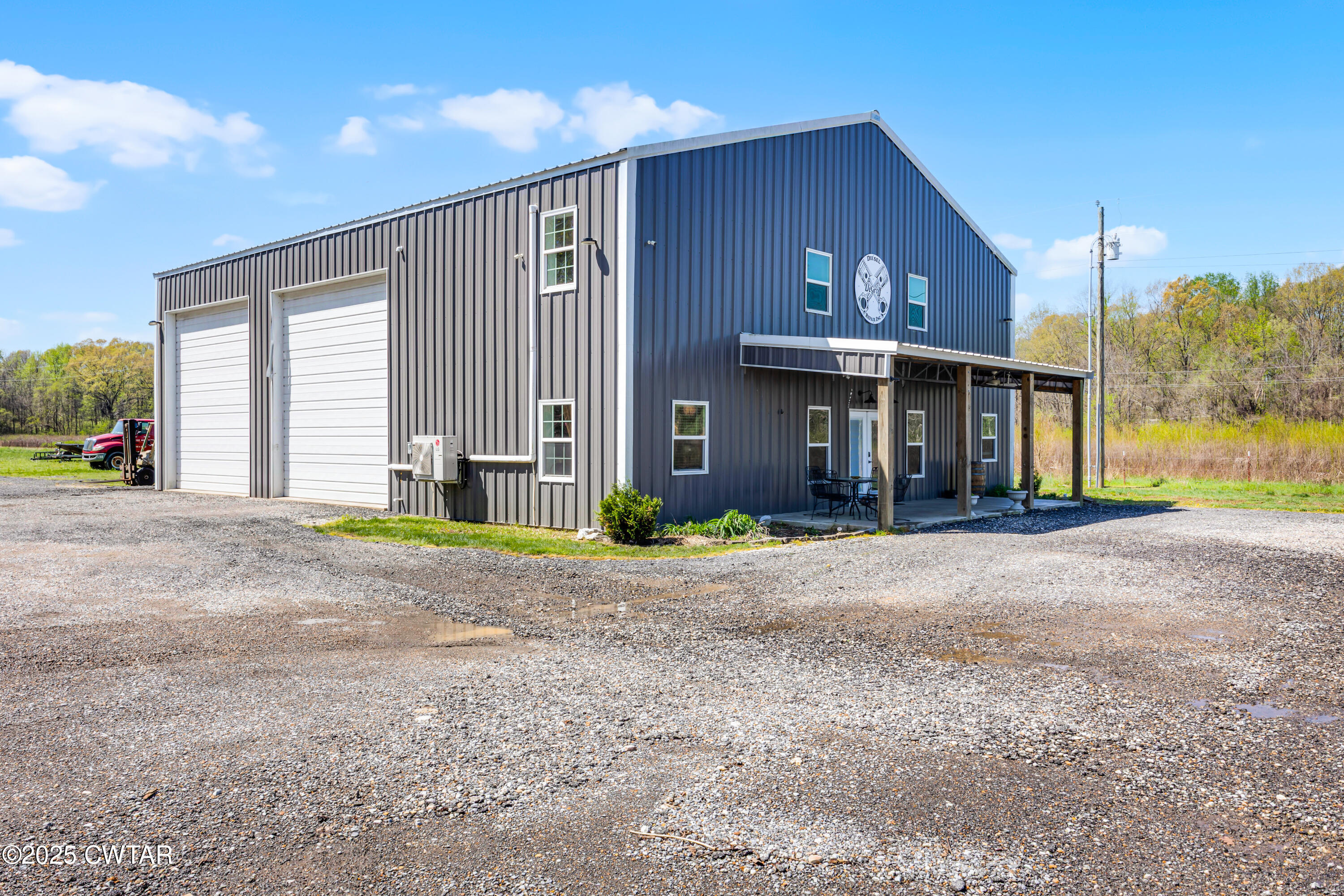 90 Dawson Bottom Road Humboldt, TN 38343 - Photo 2 of 24 a front view of a house with a yard and garage