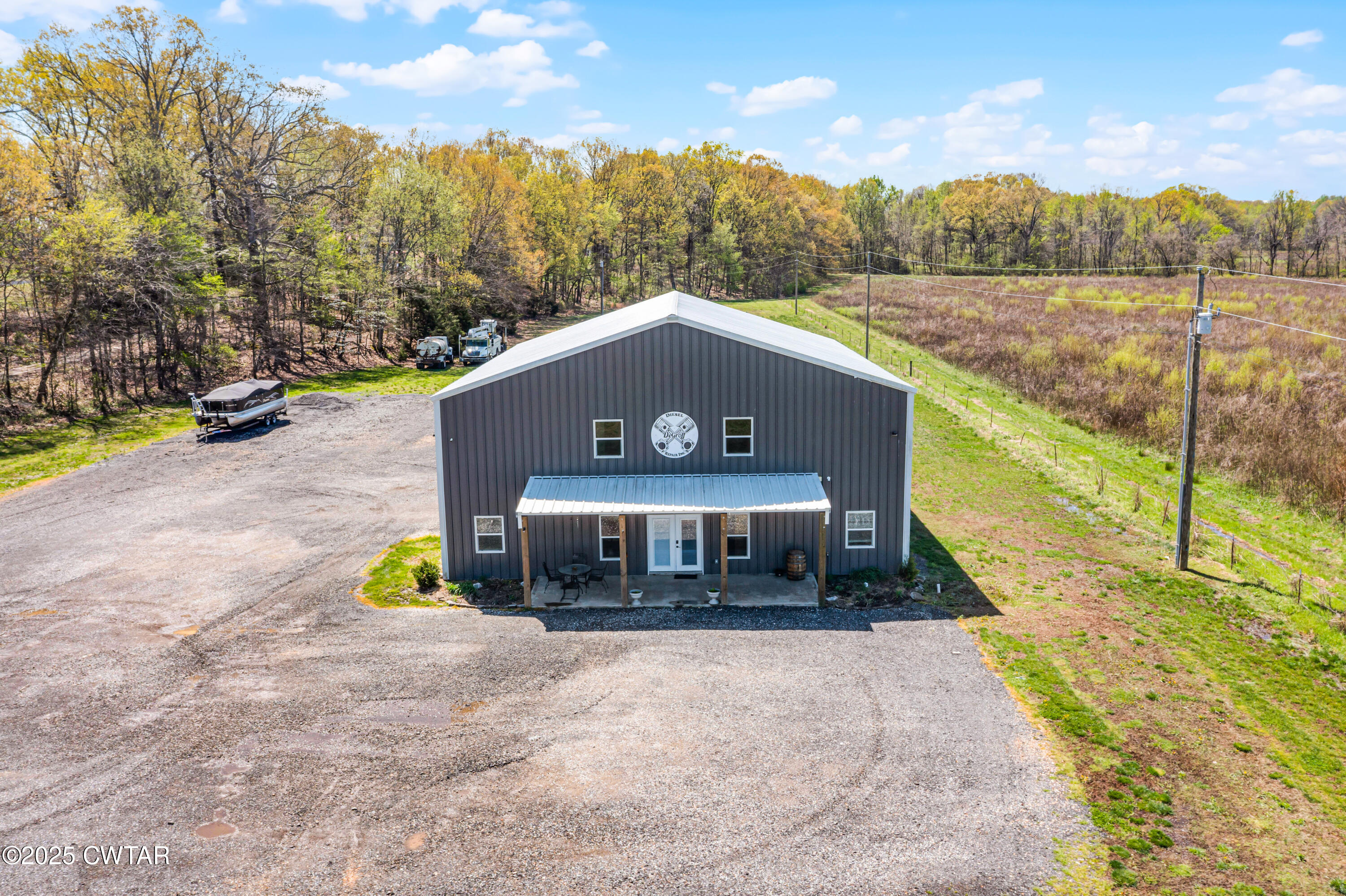 90 Dawson Bottom Road Humboldt, TN 38343 - Photo 3 of 24 a front view of a house with a yard and lake view