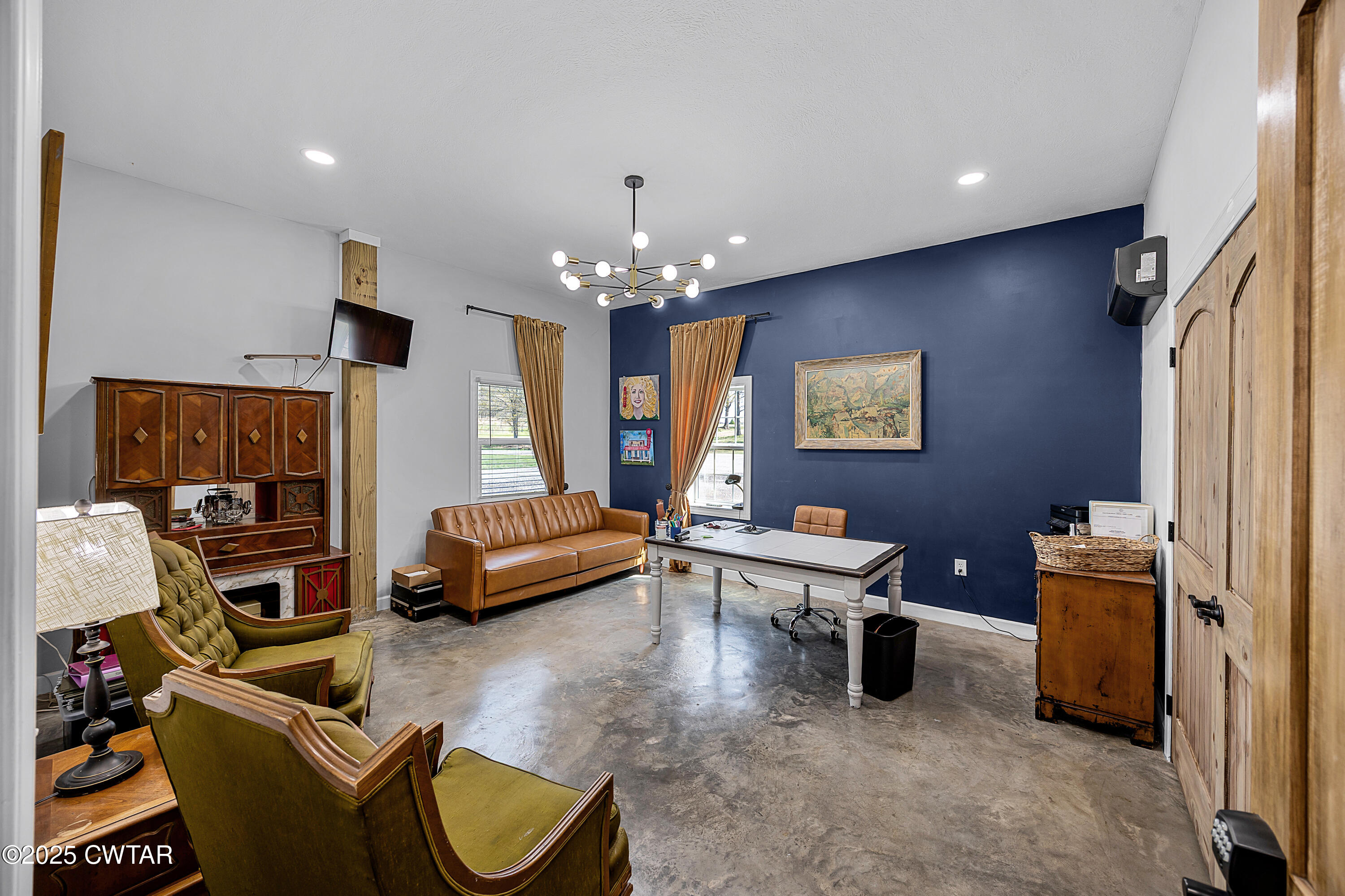 90 Dawson Bottom Road Humboldt, TN 38343 - Photo 8 of 24 a living room with furniture and a chandelier