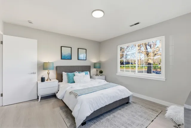 a bedroom with a large bed and a window