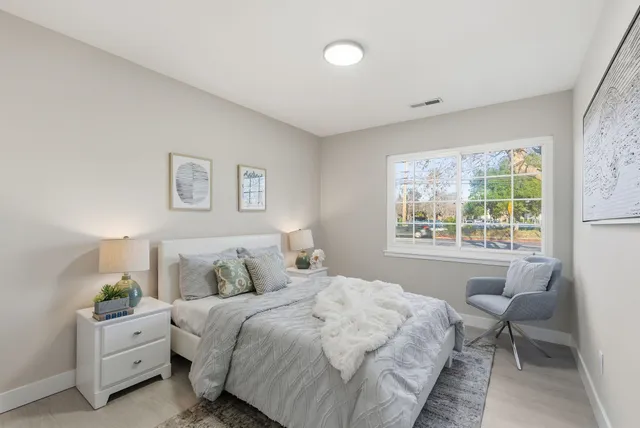 a bedroom with a bed and a window