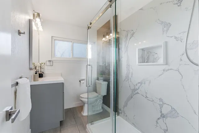 a bathroom with a toilet sink and shower