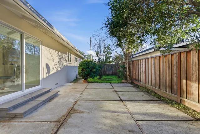 a view of a backyard with wooden fence