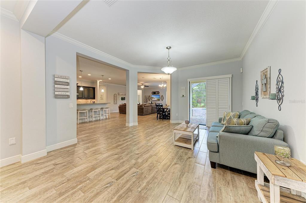 12642 Harney Street Venice, FL 34293 - Photo 10 of 85 a living room with furniture and a wooden floor