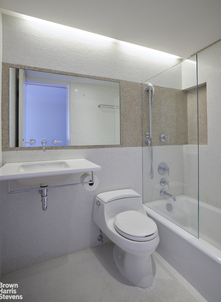 110 East 71st Street, Unit 19 Manhattan, NY 10021 - Photo 10 of 15 a bathroom with a toilet a sink and bathtub