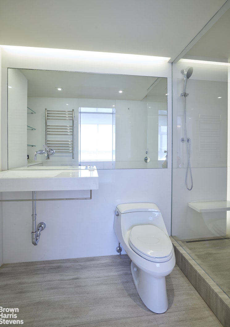 110 East 71st Street, Unit 19 Manhattan, NY 10021 - Photo 7 of 15 a bathroom with a sink a toilet and shower