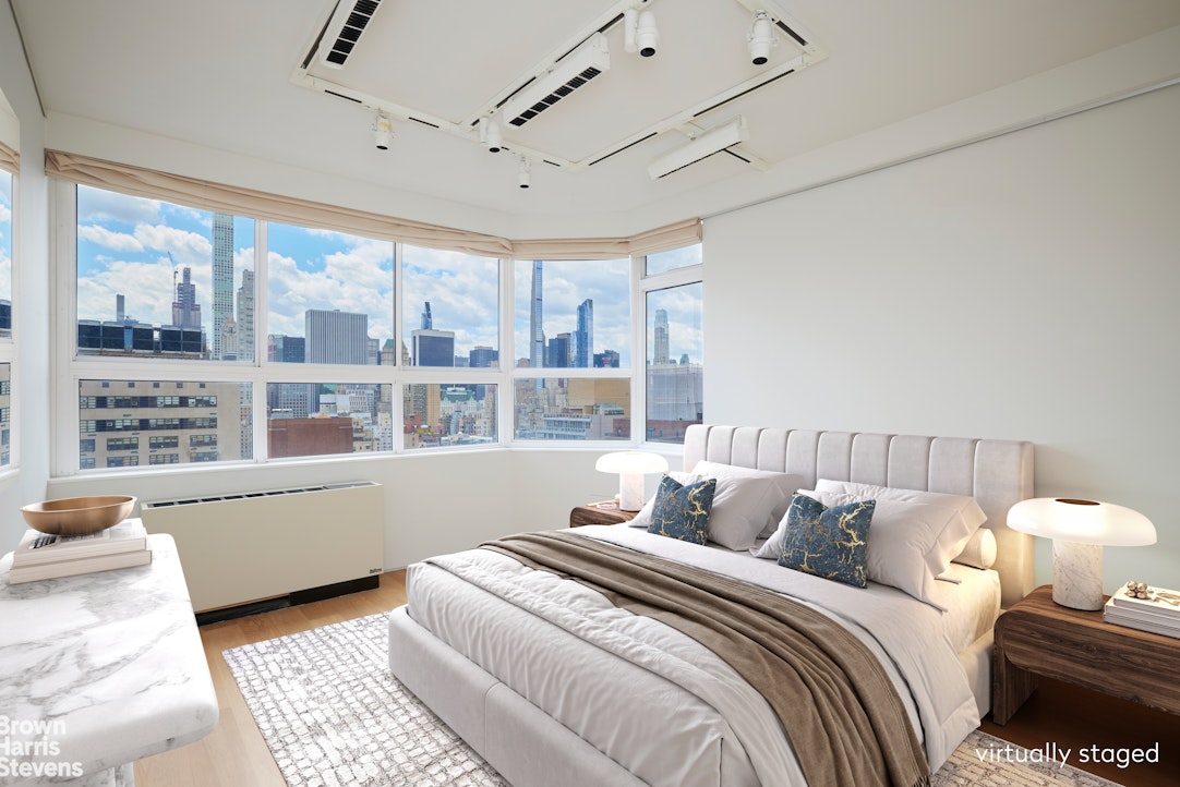 110 East 71st Street, Unit 19 Manhattan, NY 10021 - Photo 8 of 15 a bed room with a bed and a large window