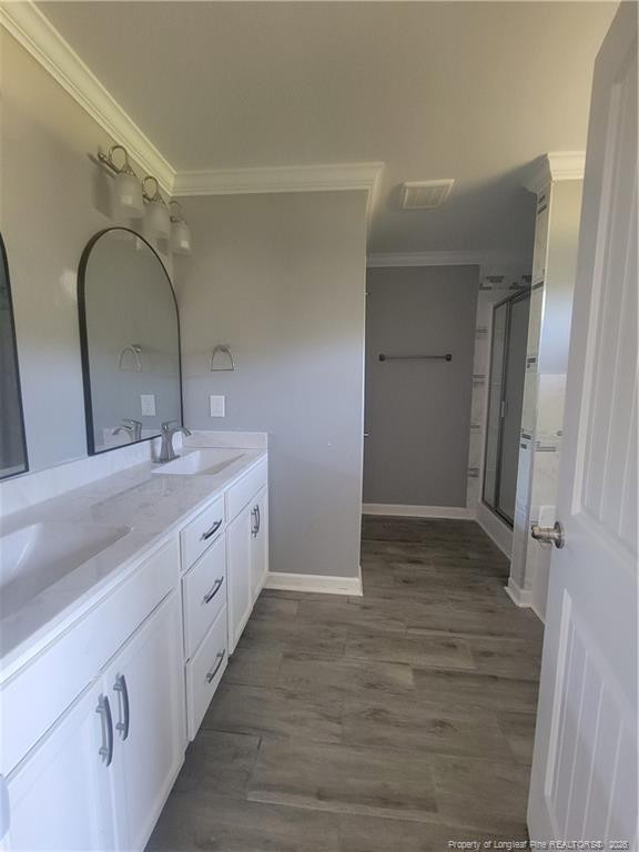 2960 H H Clark Road Fayetteville, NC 28306 - Photo 27 of 33 a bathroom with a double vanity sink and mirror