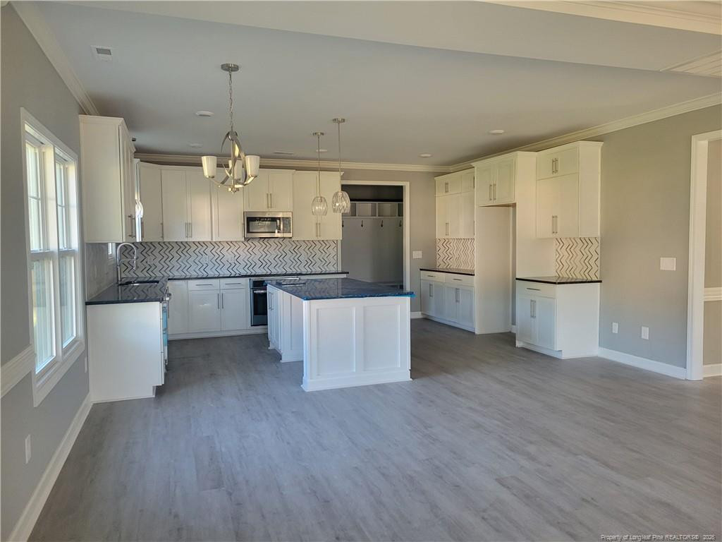 2960 H H Clark Road Fayetteville, NC 28306 - Photo 5 of 33 a open kitchen with white cabinets and stainless steel appliances